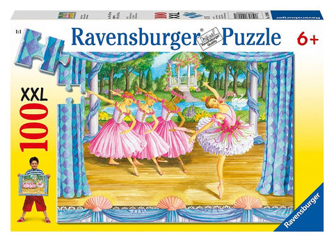 Dėlionė Ravensburger 100 XXL su baleto scena — dėžės priekinė pusė su rožiniais balerinos kostiumais ir geltonu rėmu