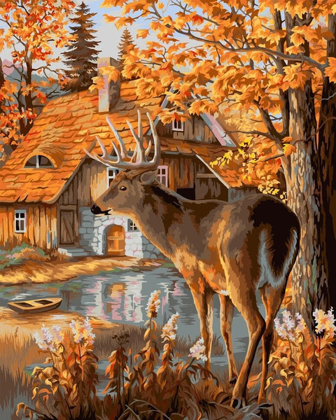 Drobė su elniu rudeninėje sodyboje, 60×80 cm, šiltų auksinių tonų, pilnas kadrą rodanti namelio ir ežerėlio sceną