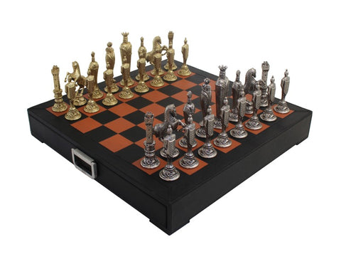 Šachmatai su auksinėmis ir sidabrinėmis metalinėmis figūromis ant rudos‑juodos sulankstomos lentos su rankena