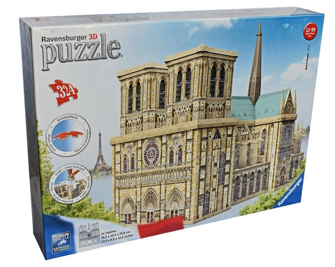 3D dėlionė Ravensburger Notre‑Dame, smėlio spalvos 324 dalių surenkamas gotikos pastato modelis ant dėžutės kampinėje perspektyvoje