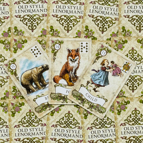 Lenormand kortos Old Style kremine dėžute, trys atverstos kortos centre (Lokys, Lapė, Vaikas) su detaliomis iliustracijomis