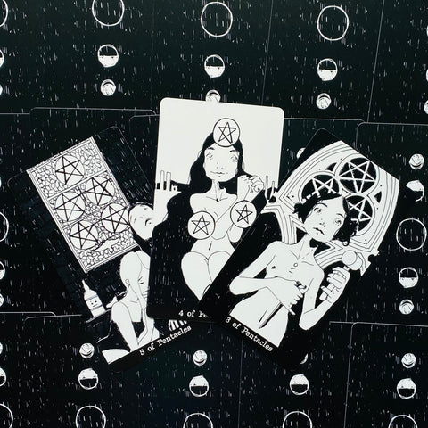 tarot kortos juodai baltos pentaklių serijos komplektas, trys iliustruotos kortos išdėstytos plokščiai fone, artimas planas, unikaliai parodytos pentakliai ir figūros