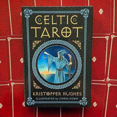 Produkto puslapyje: Celtic Tarot dėžutės priekinis vaizdas, juodas su mėlynu rėmu ir burtininko iliustracija; autorius Kristoffer Hughes