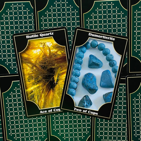 Tarot kortos su akmenų iliustracijomis: geltonas Rutile Quartz ir mėlynas Dumortierite ant tamsiai žalių nugarėlių