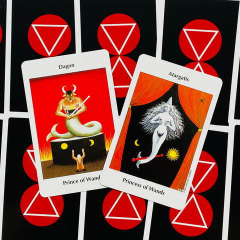 Tarot kortos su raudonomis ir juodomis nugarėlėmis, atverstos dvi kortos (Prince ir Princess of Wands) demonstruoja unikalų piešinį ir spalvas