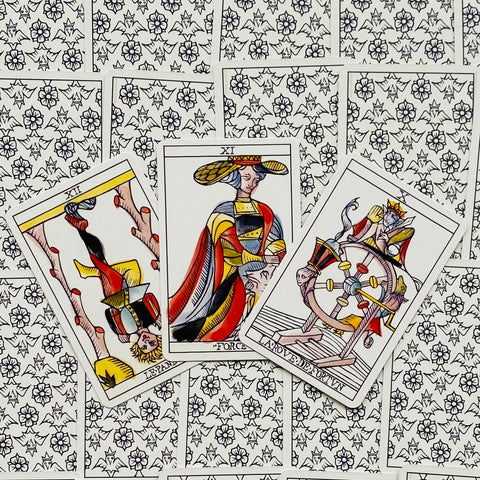 Tarot kortos Marseille stiliaus: trys didžiosios arkana kortos (Force XI, Roue de Fortune, Le Pendu) ant ornamentuoto nugarėlio