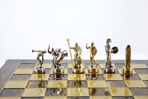 Šachmatų figūros iš aukso ir sidabro — klasikinių graikų dievų siluetų rinkinys ant marmuro imitacijos lentos