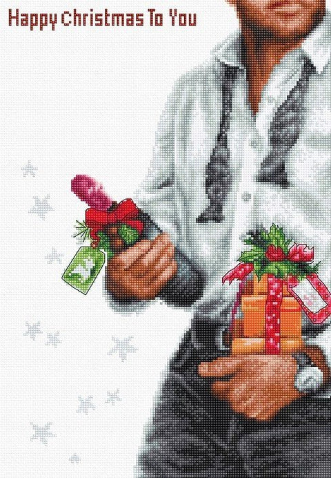 Siuvinėjimo rinkinys su vyrišku motyvu — vyras laiko dovanų ir šampano butelį ant balto fono, variantas su užrašu "Happy Christmas To You"