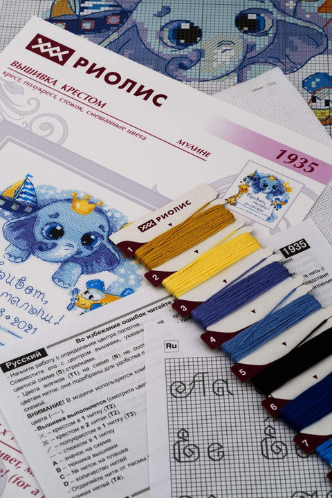 kryželių rinkinys Riolis su mėlynu kūdikio dramblio piešiniu, siūlų kortelėmis (geltona, mėlyna, juoda) ir instrukcijų schema