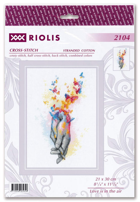 Kryželių rinkinys Riolis 21×30 cm — pilkos rankos su ryškiais, spalvotais drugeliais ant balto fono