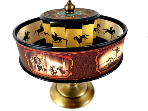 Praksinoskopas bronzinis su raudonais dekoratyviniais rėmeliais ir vidiniais veidrodžiais – artimas detalės kadras