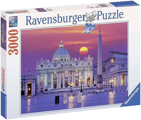 Dėlionė Ravensburger 3000 dalių, vaizduojanti Šv. Petro baziliką ir obeliską saulėlydžio fone, matoma dėžutės priekinėje pusėje