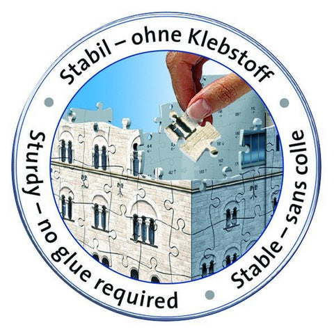 dėlionė be klijų: ranka deda paskutinį akmens pastato gabalėlį į tvirtą 3D kubo konstrukciją