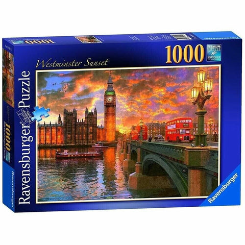Dėlionė Ravensburger 1000 dalių „Westminster Sunset“ — dėžutės priekis su Big Beno panorama ir raudonais dviaukščiais autobusais prie vakarinio dangaus