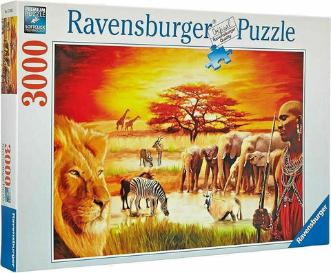Dėlionė Ravensburger, 3000 dalių, su saulėlydžio savana: liūtas, zebras, drambliai ir Maasajų vyras ant dėžutės priekio