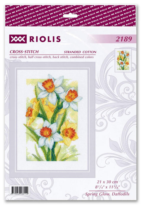 Kryželių rinkinys Riolis — narcizų motyvas, balti, geltoni ir oranžiniai žiedai; pakuotėje baigtas dizainas, 21×30 cm