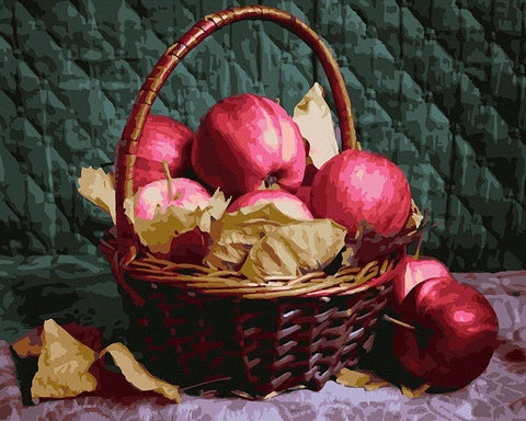 Obuoliai raudoni pintinėje su geltonais rudens lapais, šoninis rakursas pabrėžia tekstūrą ir spalvų kontrastą