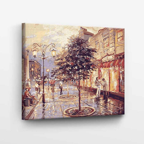 Drobė miesto vakaro scena su lietaus atspindžiais ir šiltais gatvės žibintų tonais, 40×50 cm.