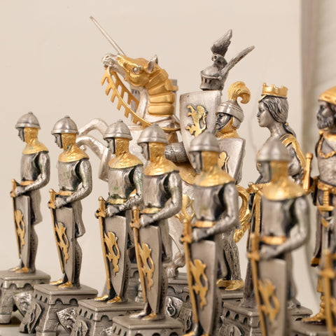 Šachmatai su sidabrinėmis ir auksuotomis viduramžių riterių figūromis, arti ir iš priekinio kampo parodytos detalės ir skulptūra
