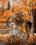 Drobė su elniu rudeninėje sodyboje, 60×80 cm, šiltų auksinių tonų, pilnas kadrą rodanti namelio ir ežerėlio sceną
