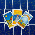 tarot kortos Rider‑Waite stiliaus, žvaigždėtu mėlynu užpakaliu, atvertos 8, 9 ir 10 taurės centriniam taro skaitymui
