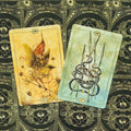 tarot kortos Hush Tarot, dvi variantų kortos — VI su geltonu fėjos dizainu ir V su žaliai-mėlynu ietų motyvu