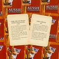 Aussie Affirmations kortos atviros dviem kortomis — Come the Raw Prawn ir Choc‑a‑Block — ant raudono koalos fono, matomas kortų tekstas