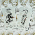 tarot kortos Angelic Arcana baltos priekinės kortos su Veualiah ir Mikhael dizainais, parodytos iš viršaus