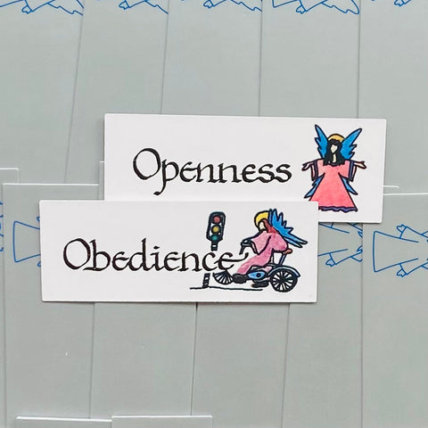 Lipdukas "Obedience" baltas, horizontalus su rožiniu angelu ant motorolerio ir mažuoju šviesoforu, priekio vaizdas