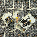 Tarot kortos Rider–Waite stiliaus, juodos ir krem spalvos nugarėlės su ornamentu ir trijų Pentaklių rūmų kortų fenu, akcentuota kortų priekinė išvaizda