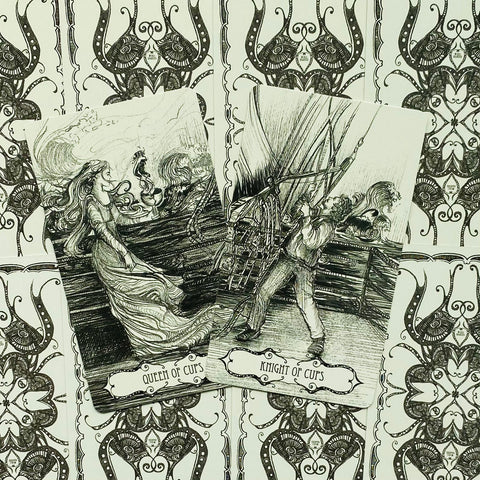 Tarot kortos juodai baltos, atverstos Queen of Cups ir Knight of Cups kortos padėtos ant ornamentuotos kortų nugarėlės