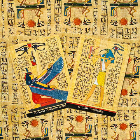 tarot kortos egiptietiško dizaino, dvi atverstos kortos (Maat ir Thot) ant senovinio papiro fono