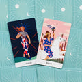 Tarot kortos — dvi Wands kortos: tamsiai mėlyna su stoja figura ir rožinė su baltu arkliu ant žydrų galinių kortų fono