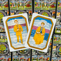 Tarot kortos — du geltoni kardų kortelių variantai stačios ant dekoratyvios juodos galinės pusės, artimas planas