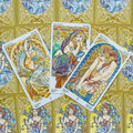tarot kortos Art Nouveau stiliaus pentaklių trys kortos išrikiuotos ant aukso ornamentuoto nugarėlio, detaliai iliustruotos feminina figura ir gėlėmis