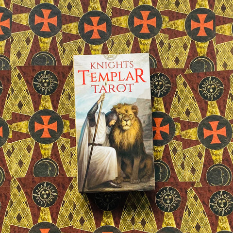 Knights Templar Tarot kortų dėžutė priekyje su liūtu ir baltai apsirengusiu riteriu, vertikaliai centre ant ornamentuoto fono
