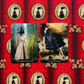 tarot kortos du dizainai: Cathedral in the Woods ir Black Silk Armor ant raudono ornamentuoto fono