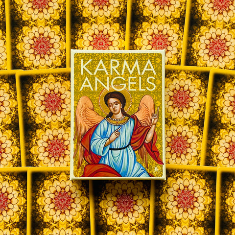 Karma Angels kortų rinkinys, dėžutė su mėlyno ir raudono angelo iliustracija ant geltono ornamentuoto fono, centre ant pasikartojančių mandalos kortelių