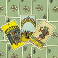 Tarot kortos Rider‑Waite stiliaus, trijų atvirų kortų rinkinys (Ten, Nine, Page of Cups) ant žalių nugarėlių, ryškūs geltoni tonai
