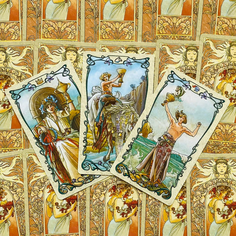 tarot kortos Art Nouveau komplektas — trys taurės aukštyn išrikiuotos kortos ant ornamentinės auksinės nugarėlės