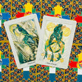 Tarot kortos su dviem atverstomis Kardų rūšies kortomis (Princess ir Prince of Swords) ant spalvoto ornamentinio fono