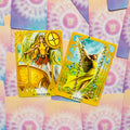 Tarot kortos – angelų dizaino priekiai: auksinė Galgaliel (16) ir gelsva Jophiel (15) ant pastelinio fono