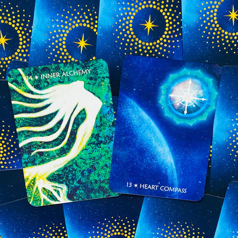 Orakulio kortos: dvi atverstos kortos — žalia Inner Alchemy ir mėlyna Heart Compass ant mėlyno žvaigždėto fono