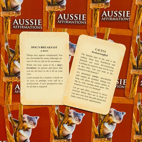 Aussie Affirmations kortos — dvi atviros versijos Dog's Breakfast ir Cactus ant raudonos dėžutės fono