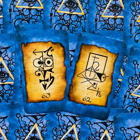 Tarot kortos su mėlynais nugarėlių raštais, dvi atvertos rudos simbolinės kortos kampu, pažymėtos 62 ir 63, skirtos paskaitai