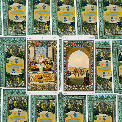 tarot kortos su žalios raštuotos nugarėlės fonu, dvi atviros centrinės kortos (5 ir 6 lazdelės) su ornamentu