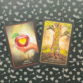 Tarot kortos su pirmaisiais paveikslais, „Apple“ (raudonas obuolys) ir „Ancestors“ (DNA medis), parodytos dizaino peržiūrai