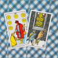 Tarot kortos Rider–Waite: penkių ir šešių monetų kortos ant mėlyno languoto fono, šiek tiek pasuktos, skirtos pranašavimui