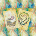Tarot kortos, dvi atverstos pastelinės kortos Renew ir Protect su elnio kaukole ir perinčiu kiaušiniu ant akvarelinio fono
