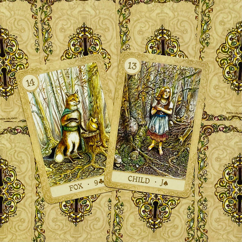 Lenormand kortų rinkinys su aukso nugarėlėmis, dvi atverstos kortos — Lapė (14) ir Vaikas (13), persidengdamos kampu